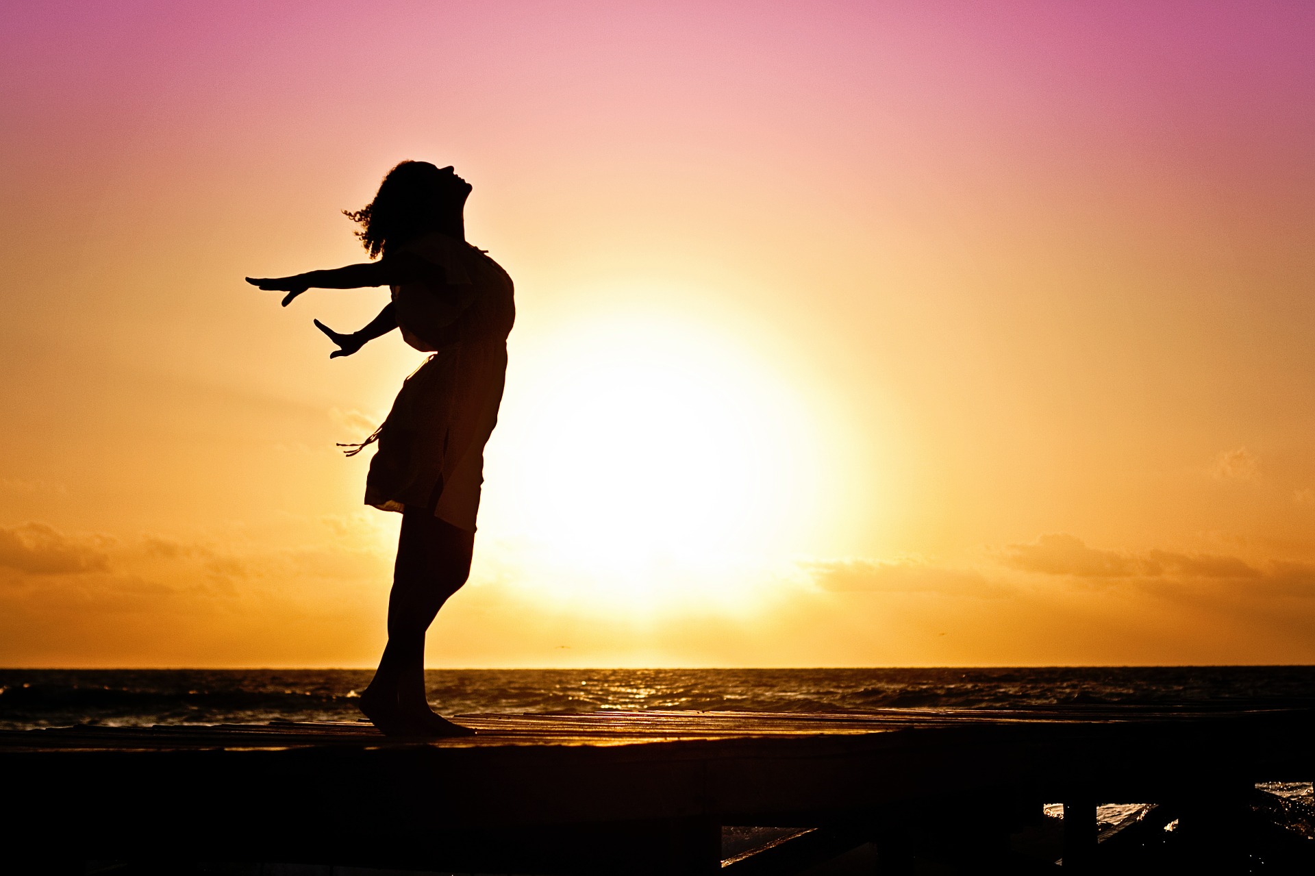 Shadowed image of woman doing yoga in sunlight